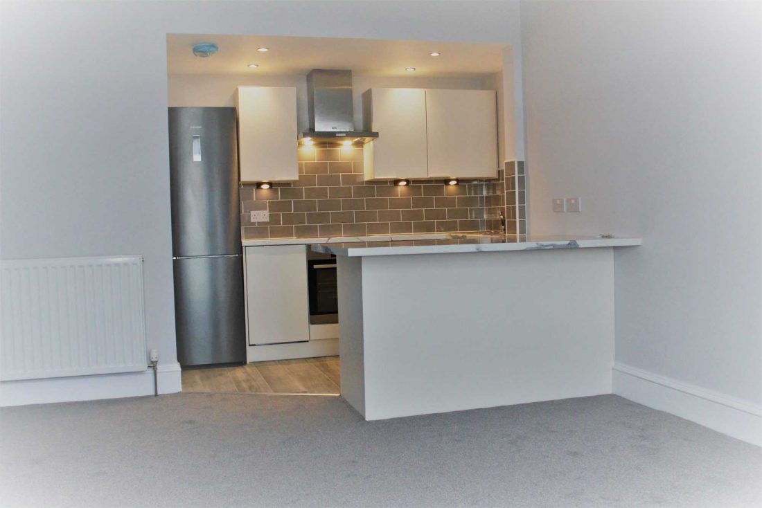 Open-plan kitchen and living area in a first-floor flat