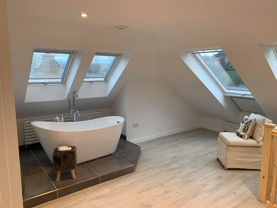 Bathroom beneath rooflights in a converted bungalow loft